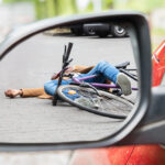 bicycle accident victim on roadway in car mirror