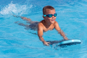 boy swimming with paddle water safety
